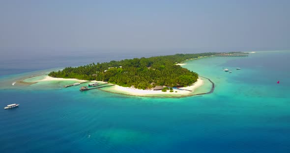 Beautiful aerial island view of a sandy white paradise beach and aqua blue ocean background in color