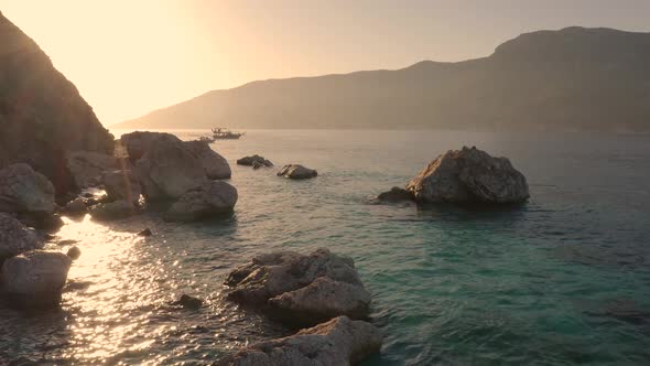 Sunset on the Rocky Shore of the Tropical Island