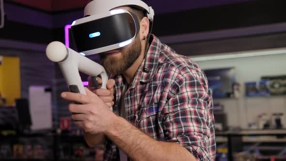 A Young Bearded Man Plays Video Games Using a Virtual Reality Headset