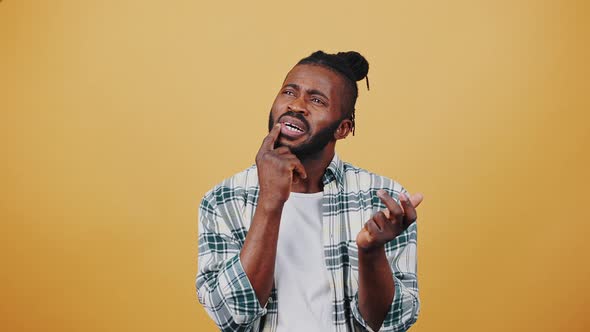 Young African American Guy Looking Confused Thinking About Something Listing It in Mind and Bending