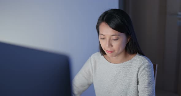 Woman work on computer at night