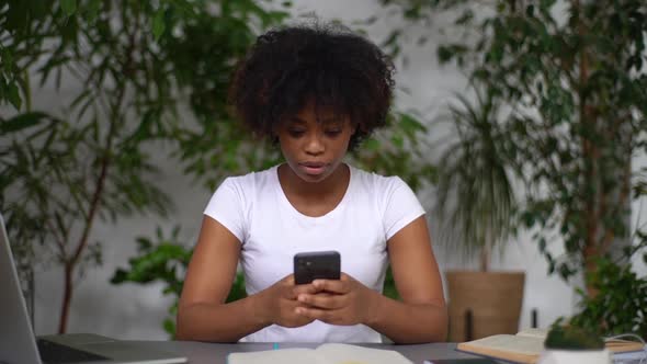 Cheerful Excited Mixed Race Woman Reading Great News on Smartphone Screaming with Joy Enjoy Success