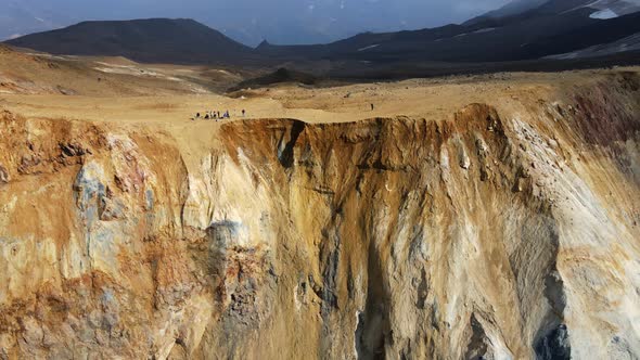 people on the edge of curating a bigger volcano