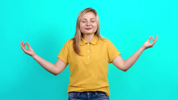 The Young Woman Does Yoga To Relax in Front of the Room.