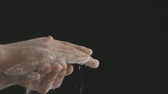 Closeup of Male Hands Shaking Off Flour