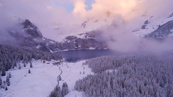 Oeschinen Lake in the Snowy Mountains of Switzerland on a Foggy Morning