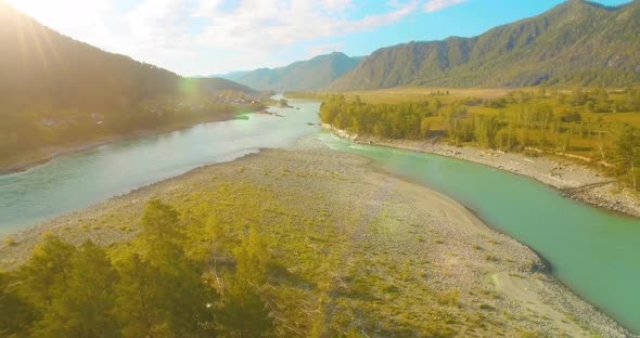 Low Altitude Flight Over Fresh Fast Mountain River with Rocks at Sunny Summer Morning