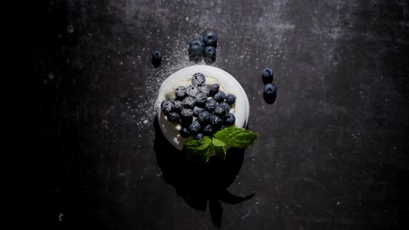 Mini Meringue Dessert Pavlova Cake with Fresh Blueberries Plased on Dark Rusty Table