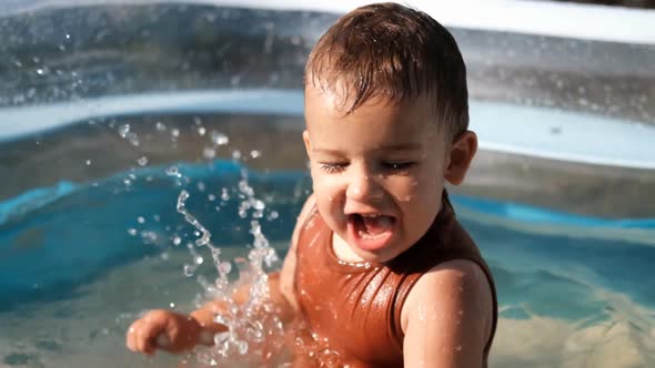 Slow Motion of Happy Little Caucasian Boy Playing in the Pool