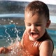 Slow Motion of Happy Little Caucasian Boy Playing in the Pool - VideoHive Item for Sale