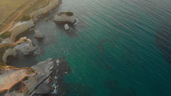 Aerial Focused Shot of Deep Green Waters By the Edge of the Cliff