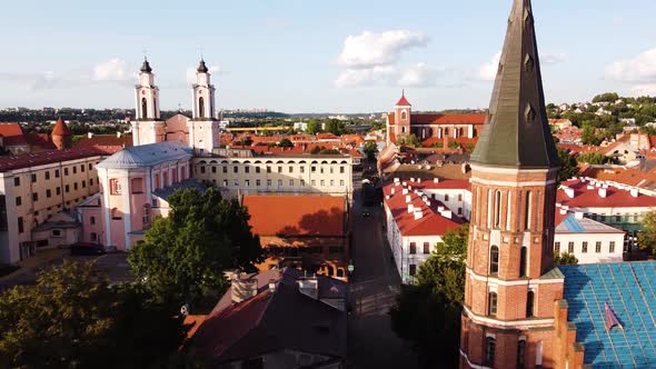 Kaunas city old town aerial drone shot while the drone is flying sideways with a beautiful church to