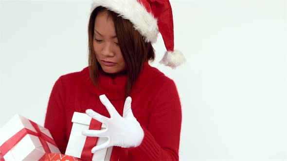 Festive woman holding pile of gifts