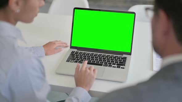 Male and Female Business Person using Laptop with Green Chroma Screen