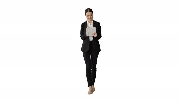 Smiling Businesswoman Using Computer Pad While Walking Towards the Camera on White Background