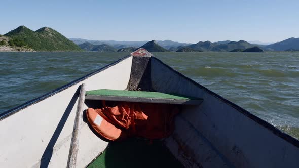 Old vintage Motor Boat Floats on the Calm  Skadar lake Water Surface Summer day
