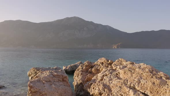 Scenic View of Sea and Mountains From Rocky Shore