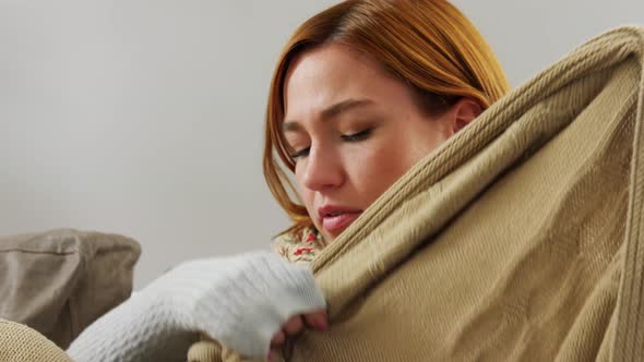 Sick Woman in Scarf Wrapping Into Blanket at Home