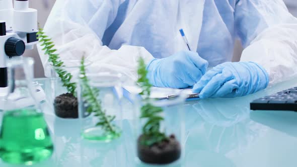 Close Up Footage of Biologist Desk Making Notest in a Clipboard