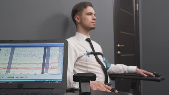 Bearded Man During Polygraph Test in Grey Office