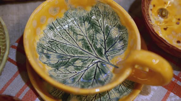 Yellow Ceramic Cup and Saucer with Leaf Inside