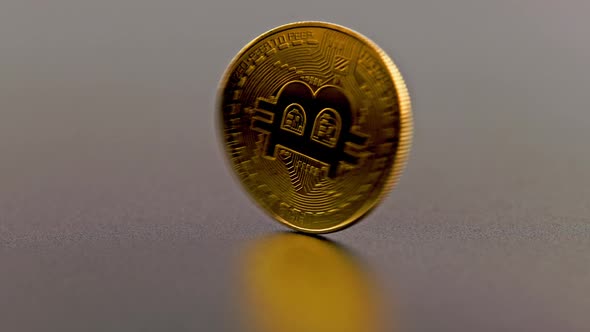 Bitcoin Coin Spinning on Gray Background  Closeup with Slowmo