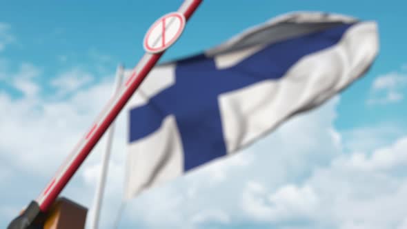 Closing Barrier with Stop Immigration Sign Against the Finnish Flag