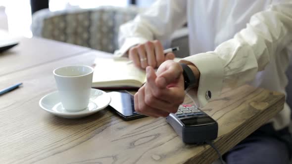 Man is Paying with a Smart Watch