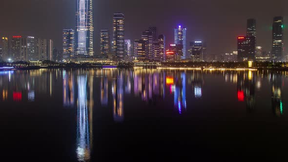 Shenzhen Urban Cityscape China Timelapse at Night with Reflection in Water Pan Up