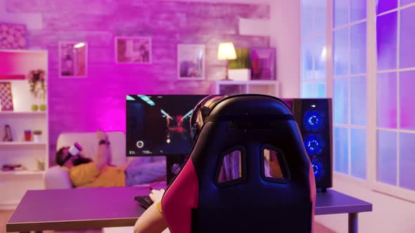 Back View of Professional Gamer Girl Sitting on Gaming Chair