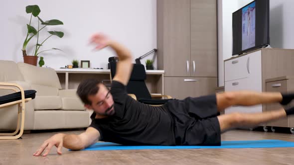 Fit Young Man Doing Crunches at Home