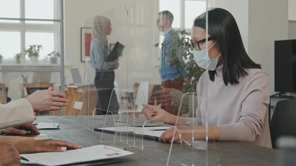 Woman in Face Mask Singing Contract at Job Interview