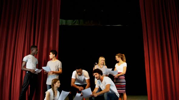 Actors discussing their scripts on stage 4k