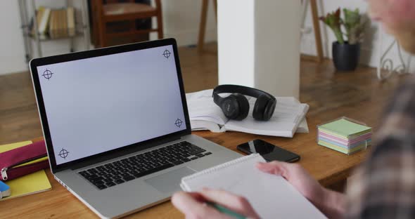 Albino african american man with dreadlocks working and using laptop