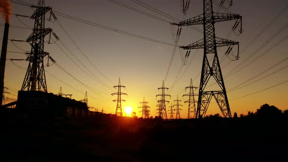 Transmission towers at orange sunset