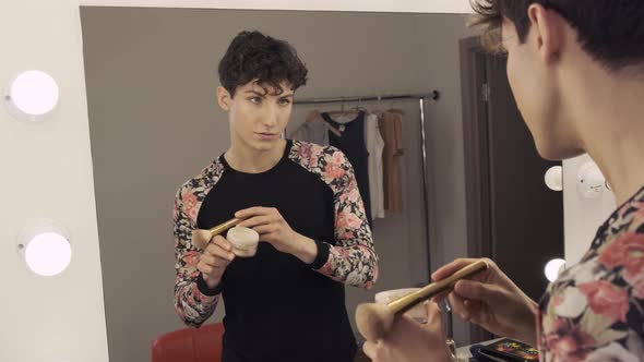 A Metrosexual Is Applying Powder with a Brush To His Face