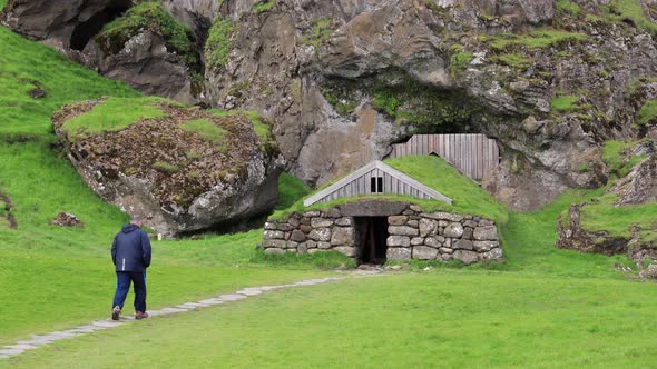 Man walking towards Stone Hut in Iceland 4K