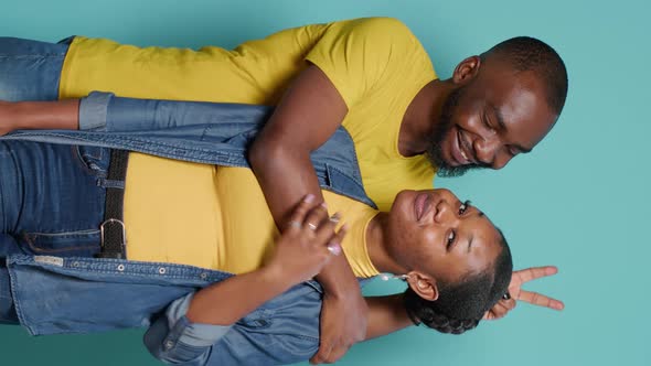 Vertical Video African American Couple in Embrace Showing Peace Sign with Hands