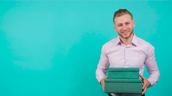 Young Handsome Man Who Gives a Gift Box, Looking at the Camera, Copy Space