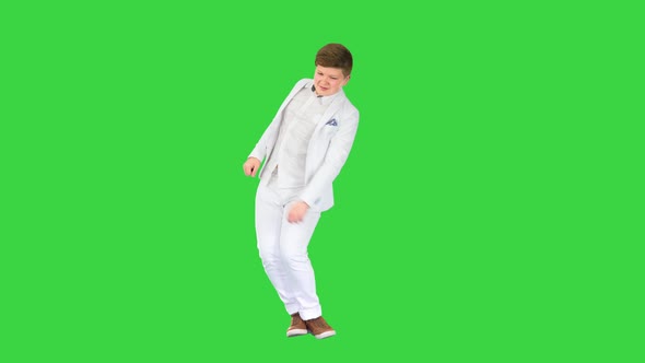 Young Boy in a White Suit Dancing on a Green Screen Chroma Key