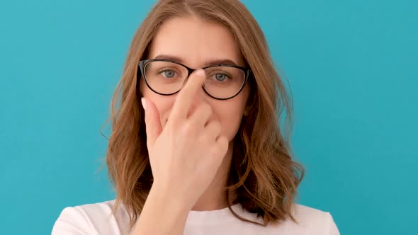 Young Woman Putting Glasses