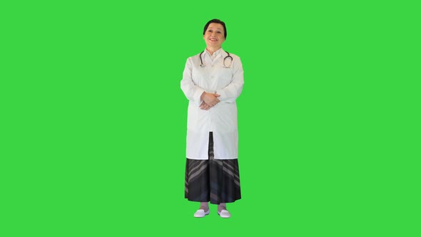 Happy Senior Female Doctor Standing on a Green Screen Chroma Key