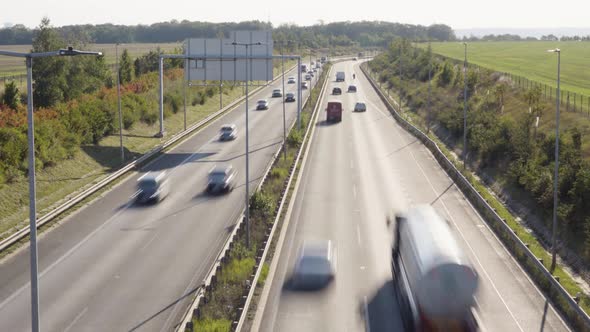 Cars and Trucks Drive on a Busy Highway in a Rural Area  Time Lapse  Top View