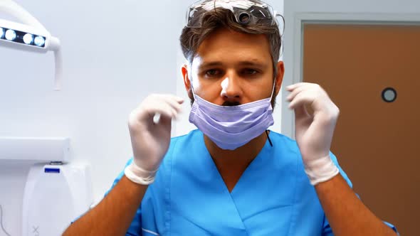 Dentist wearing protective eyewear and surgical mask