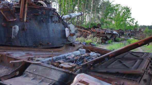 Row of Destroyed Military Tanks Outdoors on Suburban Road Near Kyiv Ukraine