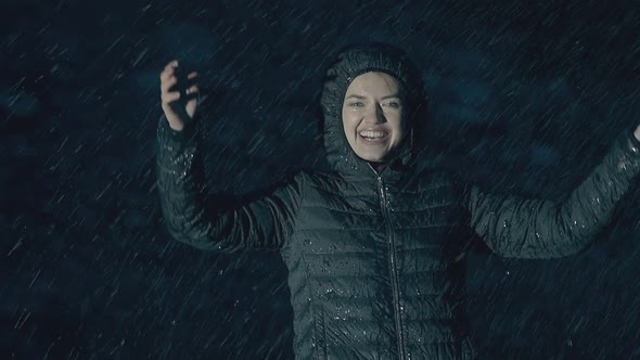 Raindrops Fall on Smiling Girl Jumping and Enjoying Life