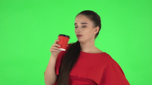 Portrait of Pretty Young Woman Is Enjoying Coffee. Green Screen