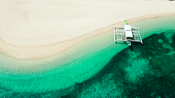 Tropical Beach of White Sand, Top View. Tourist Boat Off the Coast. Tranquil Beach Scene.