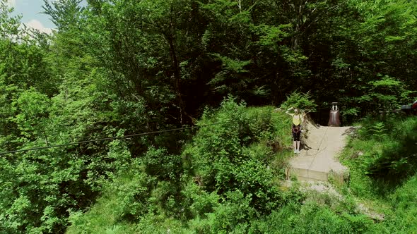 Aerial view of person zip-lining in Soca valley, Slovenia.