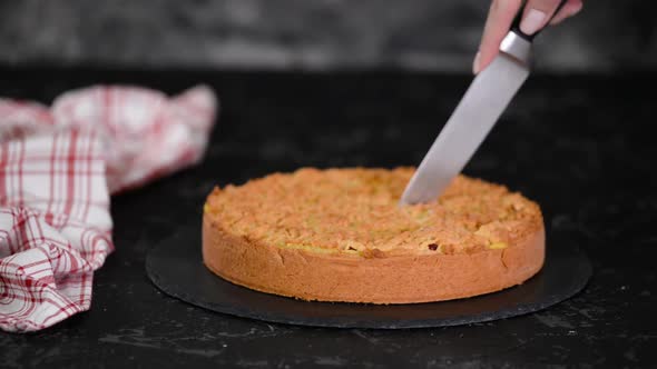 The Girl Cuts Delicious Cherry Cake with Shortcrust Pastry.